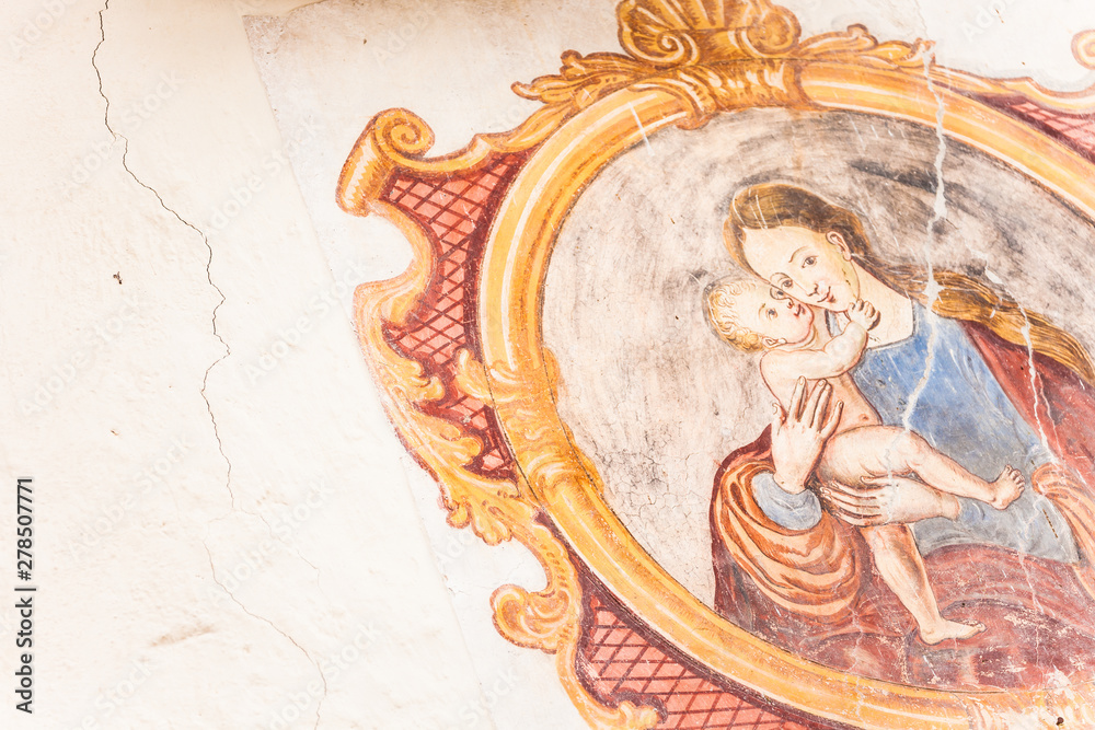 A detail of an old fresco painted on the external wall of the little chapel of St. Johan in Val di Funes