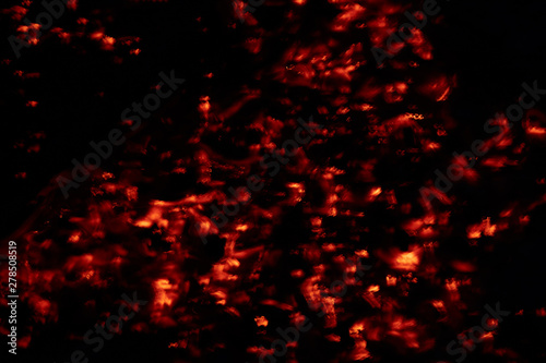 Abstract photo of glowing red coals on a dark background