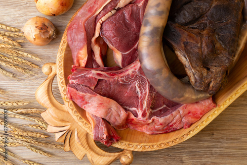 .Kazakh national wooden tableware Astau with horse meat for cooking national dish Beshparmak photo