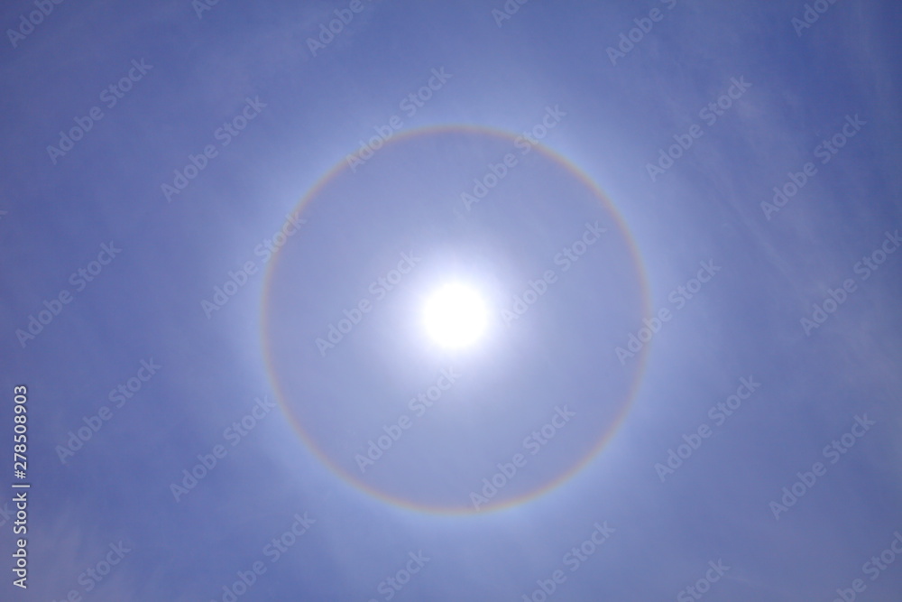 Stunning ring of sun halo with deep blue sky on sunny day