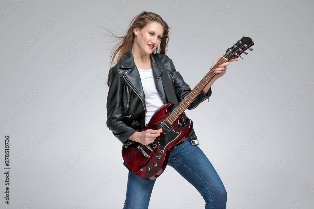 Positive guitarist girl playing and smiling Positive guitarist girl playing and smiling