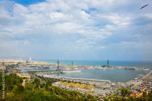 View on Barcelona port from Montjuic castle. Harbour with ships in the city. Cruise liner on the water.