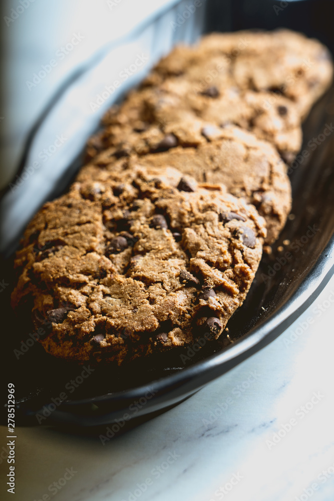 presentation of chocolate biscuits on a black plate