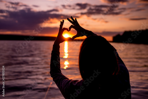 silhouette of a woman at red sunset