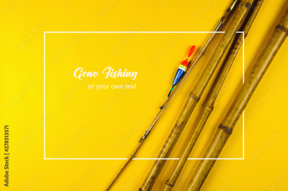 Old bamboo fishing rod on yellow background Stock Photo
