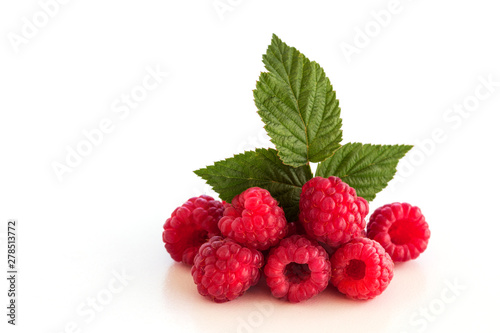 Still life. Ripe, red raspberry berries with green leaf on a white background. Close-up. Isolated.