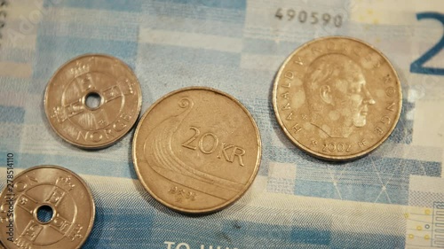 Norwegian Kroner Coins on top of a 200 Kroner bill. Panning right shot photo