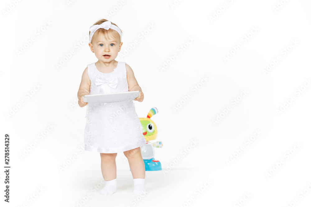 little girl all in white with tablet and toy little girl all in white with tablet and toy