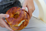 Turkish achma bagels in man's hands, bagels from bakery, fresh bread