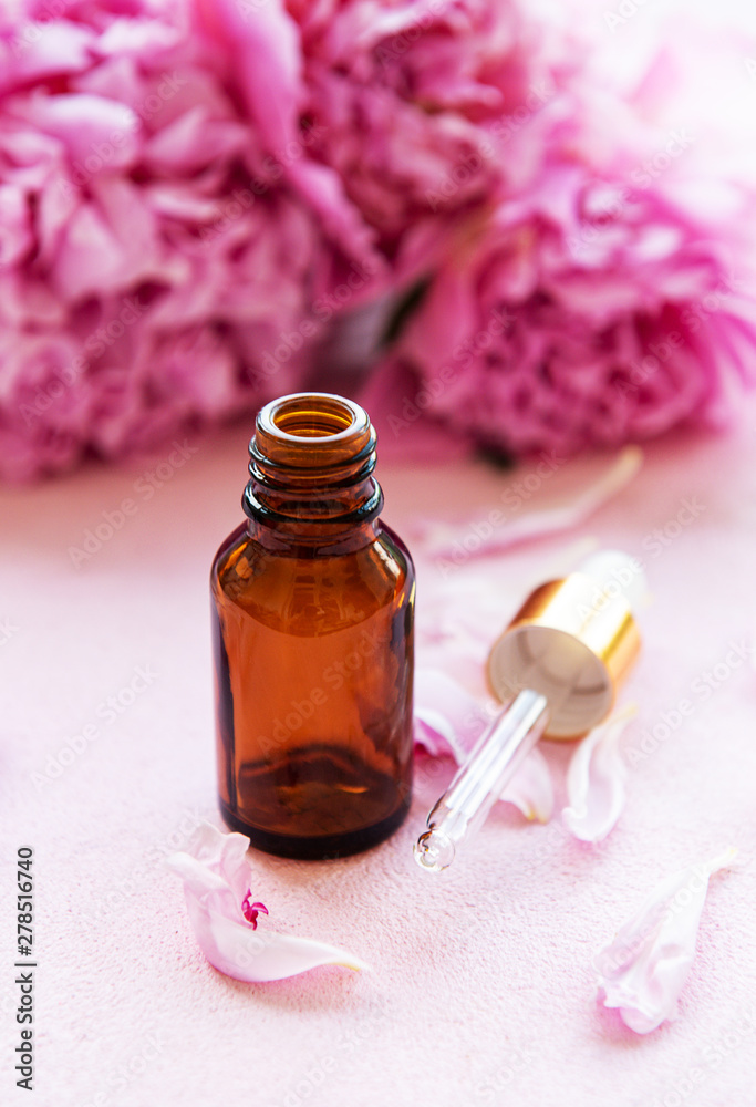 Aromatherapy essentials oils and pink peonies Aromatherapy essentials oils and pink peonies