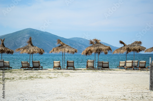 View of the beach with umbrellas and deck chairs in Albania © Valentyn Panchuk