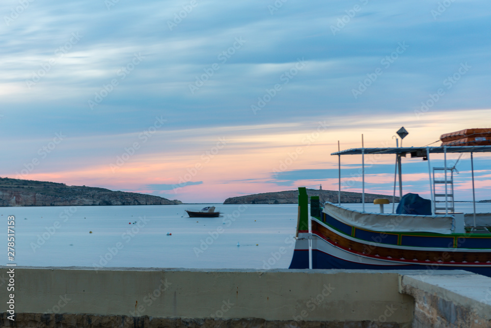 The panorama of harbour on St Paul's Bay with fishing boats and tourist ships, Bugibba, Malta