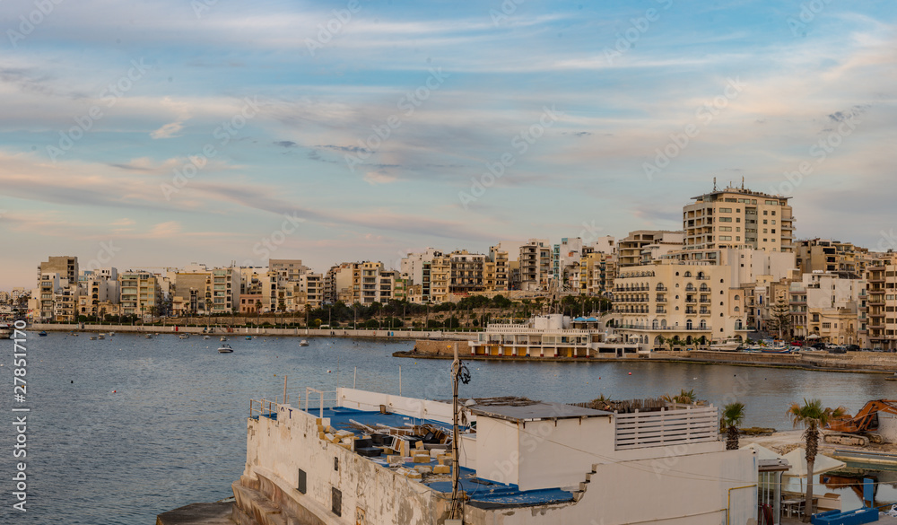 The panorama of harbour on St Paul's Bay with fishing boats and tourist ships, Bugibba, Malta