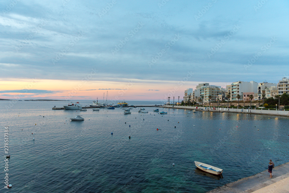Fototapeta premium The panorama of harbour on St Paul's Bay with fishing boats and tourist ships, Bugibba, Malta