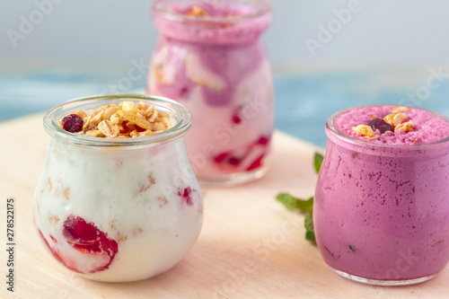 Granola with yogurt and berries for healthy breakfast on a table