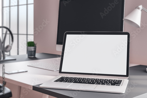 Designer desktop with white laptop