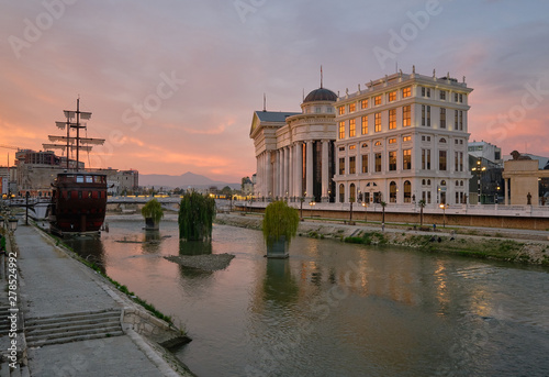 Skopje river front at sunset, featuring new constructions built and an anchored mast boat