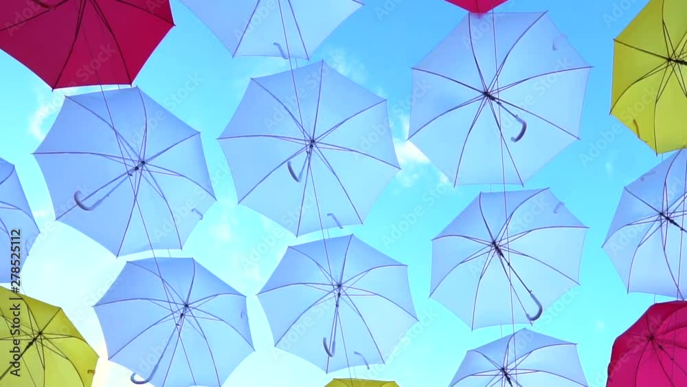 Tilt shot of the colorful umbrellas hanging in the sky. Street Decorated With Colored Umbrellas Tilt shot of the colorful umbrellas hanging in the sky. Street Decorated With Colored Umbrellas