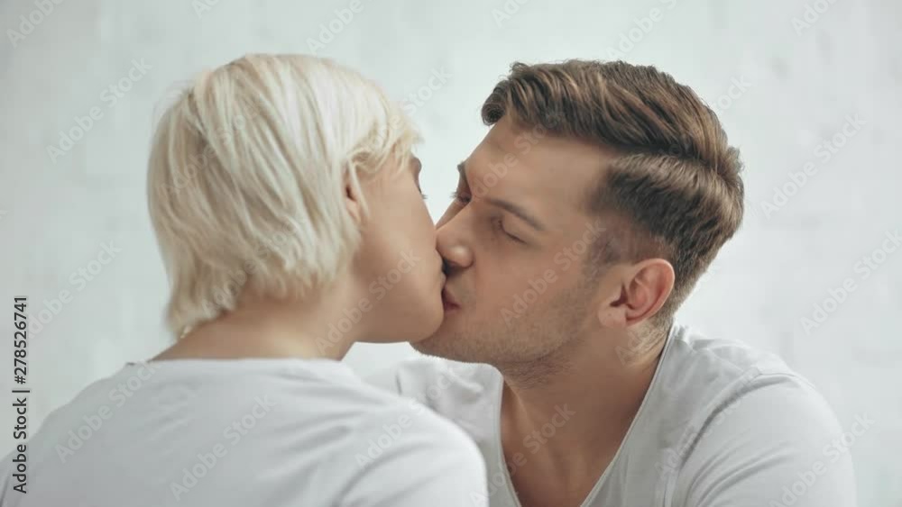 beautiful couple looking at each other, smiling and kissing at home beautiful couple looking at each other, smiling and kissing at home