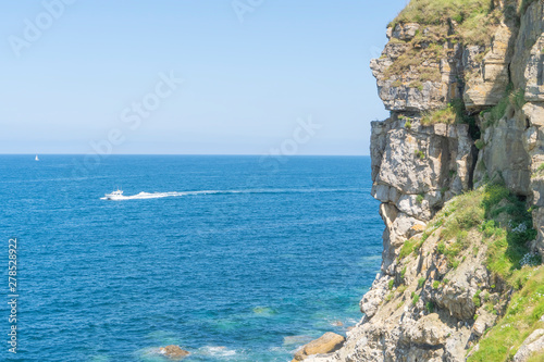 Wild rocks on the shore of a calm ocean