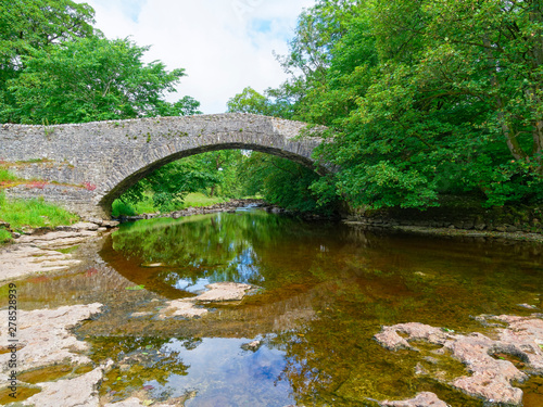 The River Ribble passes under an old stone bridge near Stainforth
