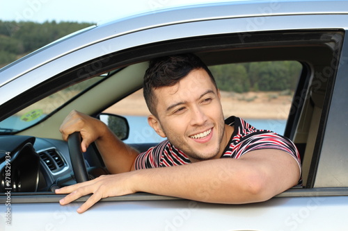 Handsome ethnic driver looking at view