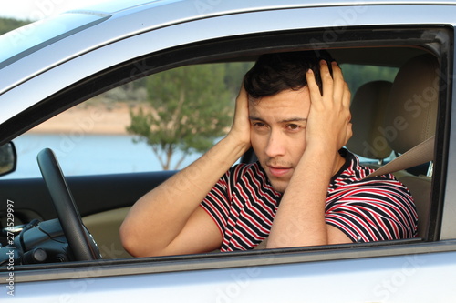 Fotografie Terrified young male driver feeling guilty