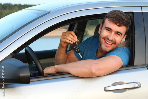 Driver showing car keys with satisfaction 