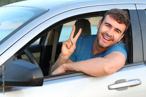Relaxed driver showing peace sign 