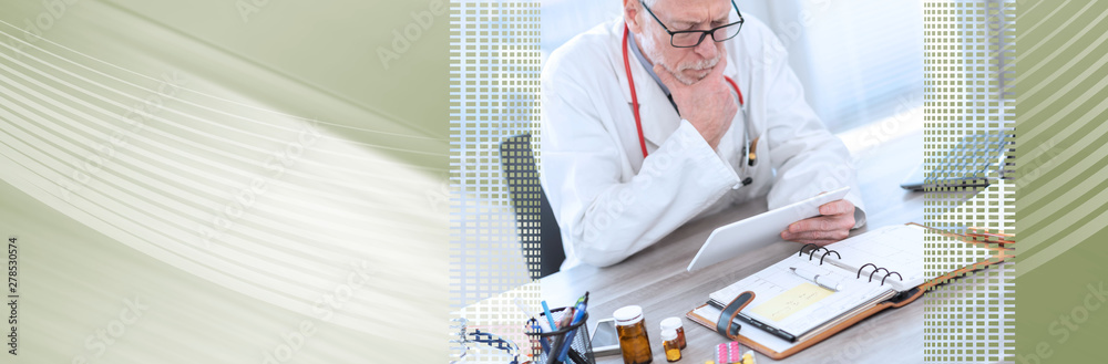 Male senior doctor using digital tablet; panoramic banner Male senior doctor using digital tablet; panoramic banner