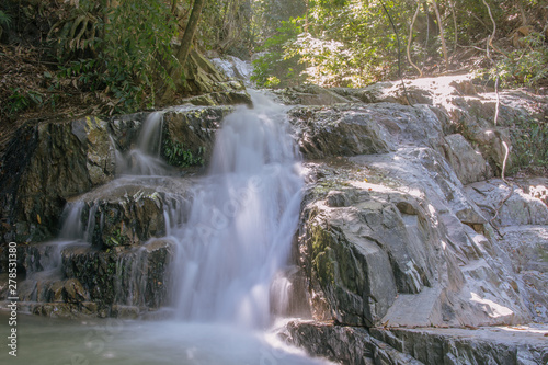 Streams in the tropical rainforest washed down from the rocks to form a beautiful waterfall, long exposition