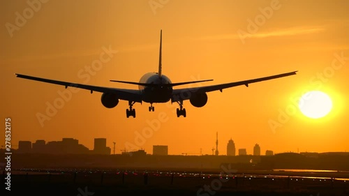 Landing airplane in morning sky photo