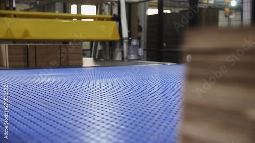 folded cardboard boxes blocks transported by blue conveyor photo