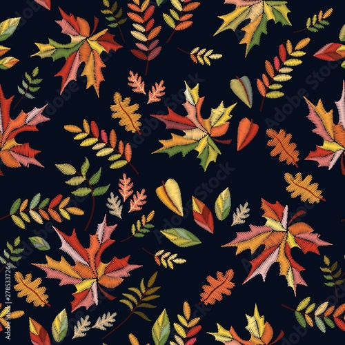 Bright embroidery seamless pattern with colorful autumn leaves on black background.