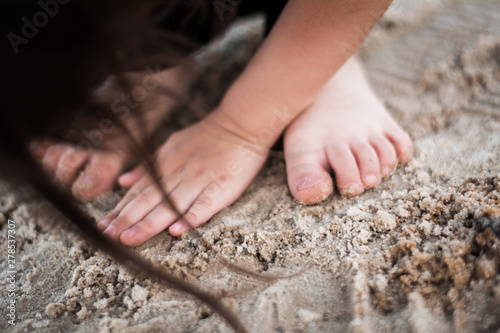 child legs flip flops shoes hat sand bling suit glasses child's hand