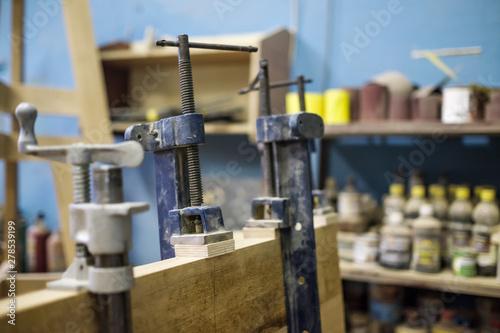 Joinery work. Using clamps and glue to connect wooden timbers for furniture detail