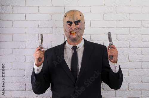 man in a suit in the mask of a maniac