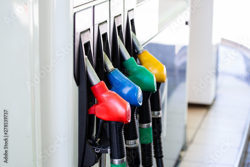 Gas pump nozzles in service station. Colorful Petrol pump filling nozzles, Gas station in a service.