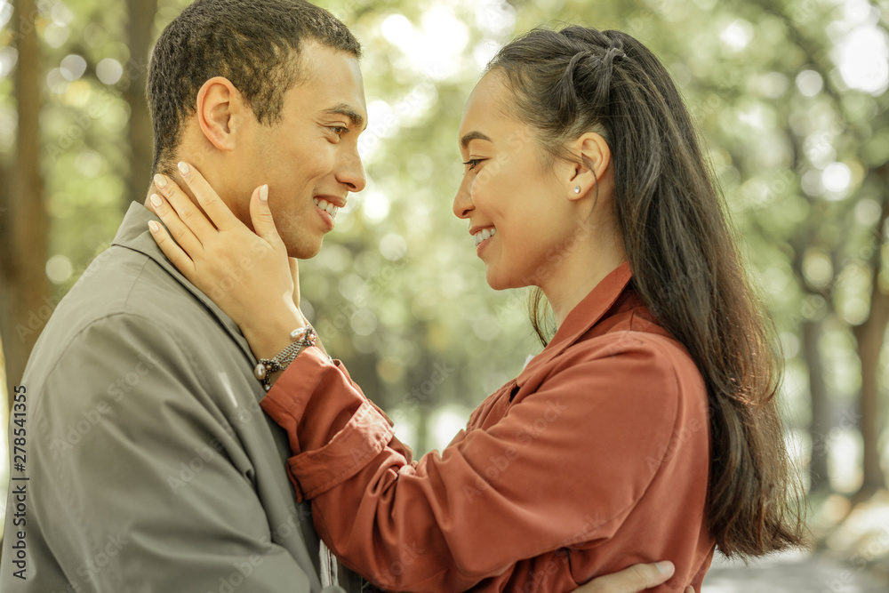 Fototapeta premium Short-haired caring man showing his feelings to appealing woman