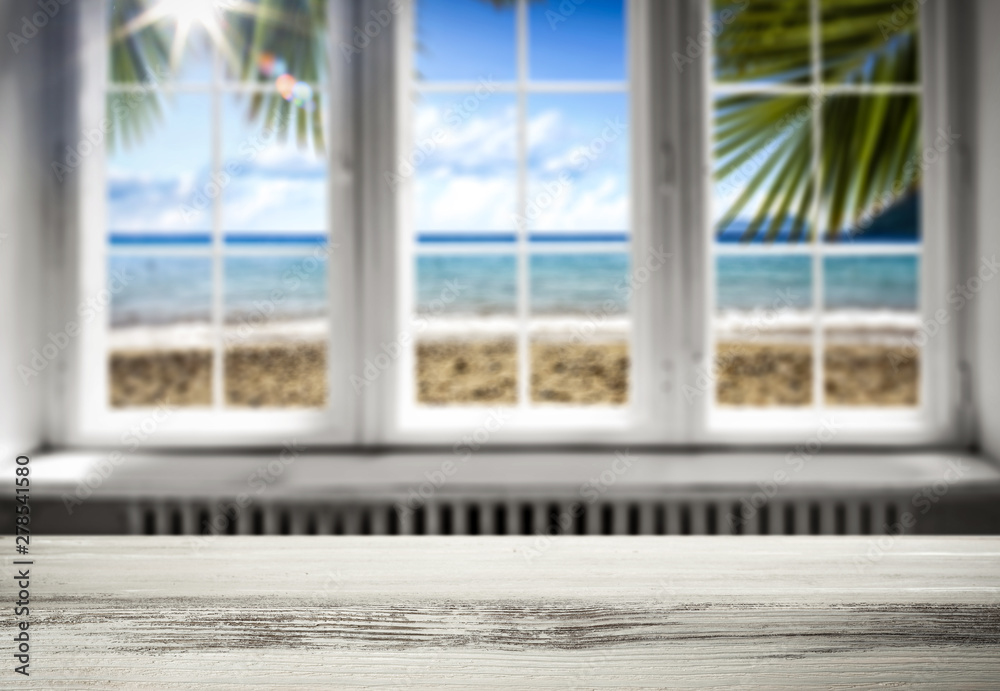 Table background with a beautiful ocean sunny window view