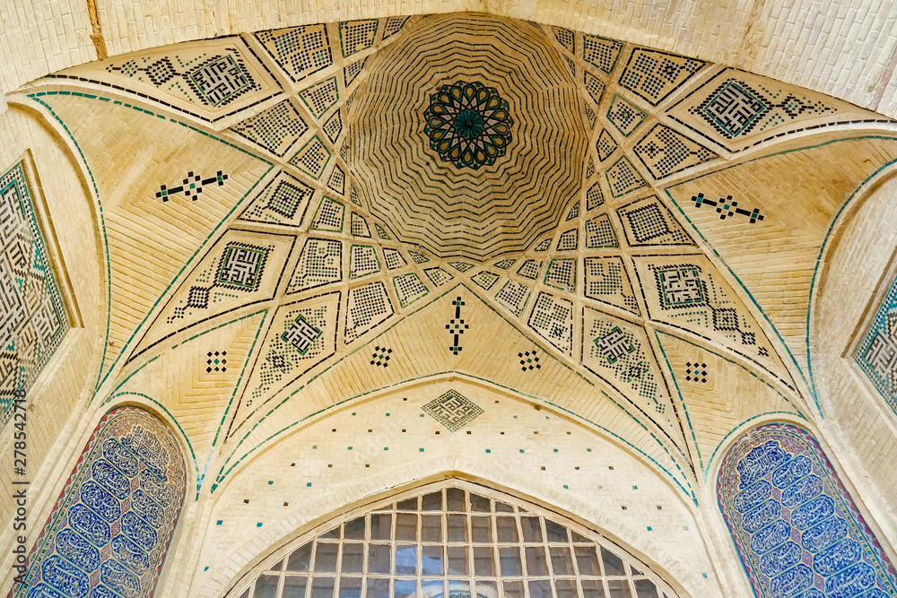 Persian dome ceiling brick and mosaic tiles pattern of a building near the Tomb of poet Hafez. Shiraz, Iran.