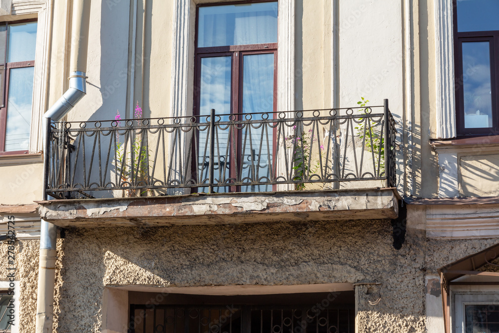 Obraz premium balcony with metal railings on the facade of an old building