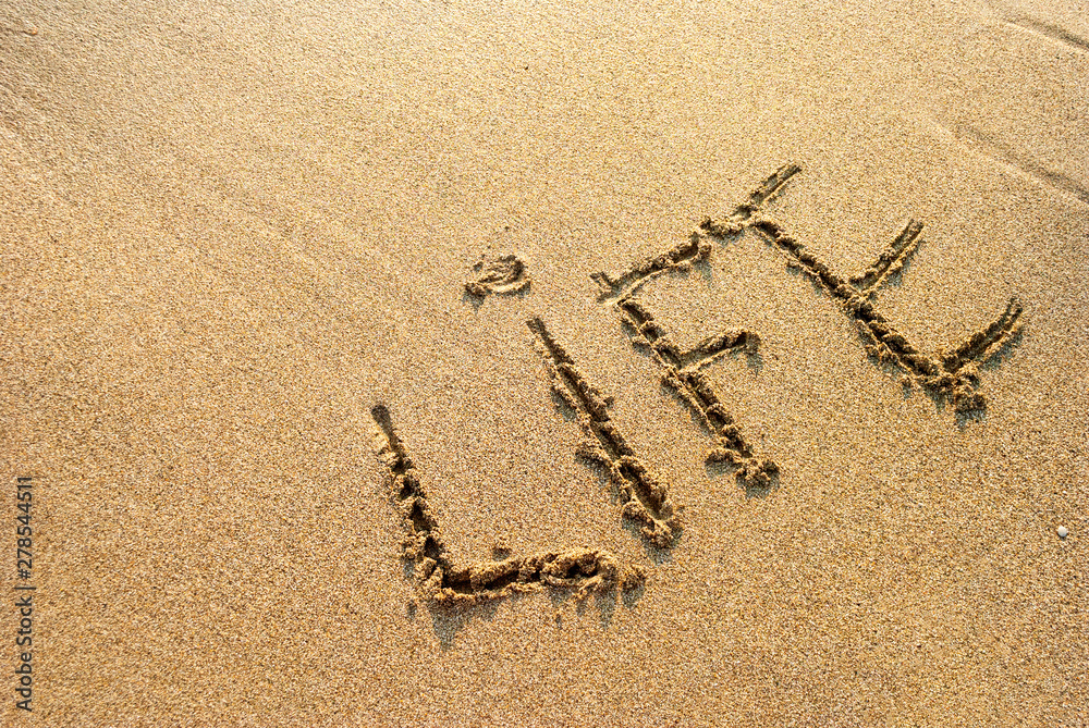 inscription on the wet sand life, footprints in the sand StockFoto