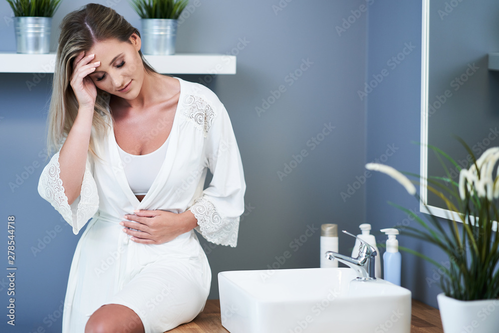 Young woman feeling unwell in bathroom Young woman feeling unwell in bathroom