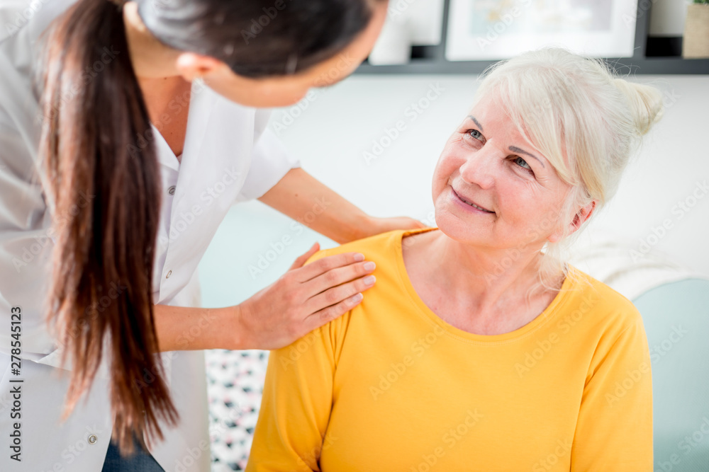 Nurse during home visit talking with senior female and giving treatment advices Nurse during home visit talking with senior female and giving treatment advices