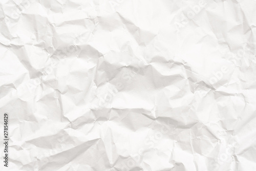 Modern crumpled white paper on empty sheet gray background with light shadows for creative wallpaper, card, art work design.