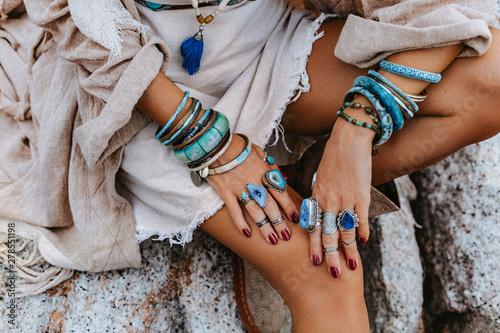 close up of young woman with lot of boho accessories outdoors