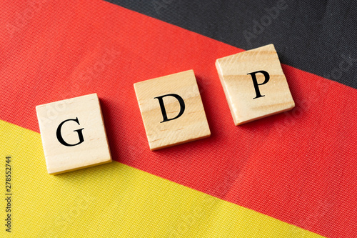 Concept of Gross Domestic Product or GDP of Germany, GDP in wooden block letter on German Flag. photo