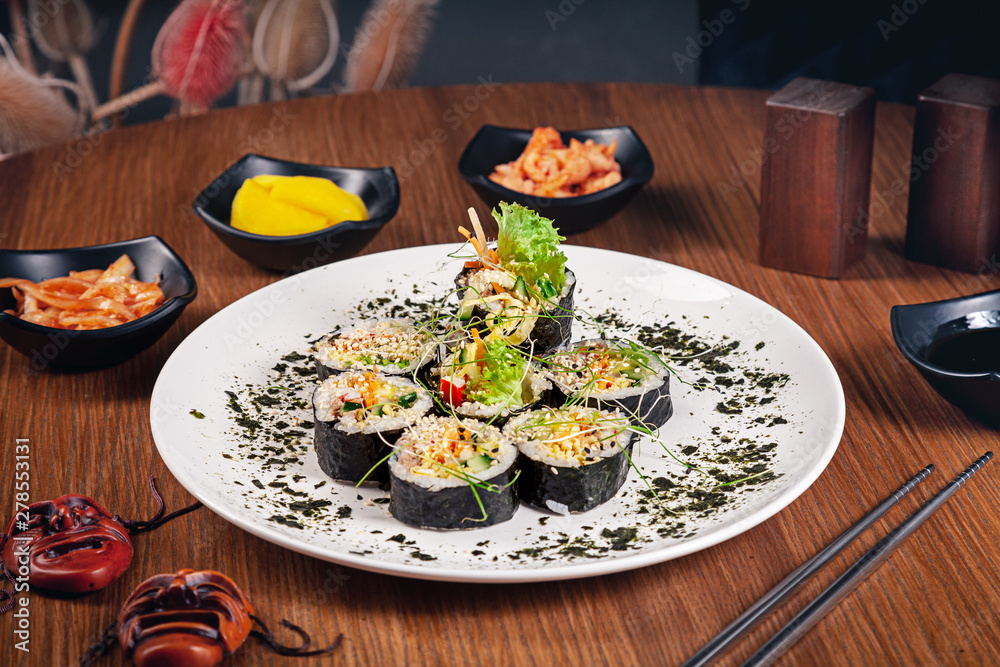 Traditional korean roll gimbap. Suchi roll with tuna. Meat. Traditional korean cuisine set. Restaurant food background. Kimbap served with kimchi on wooden background. Seafood. Healthy food fish