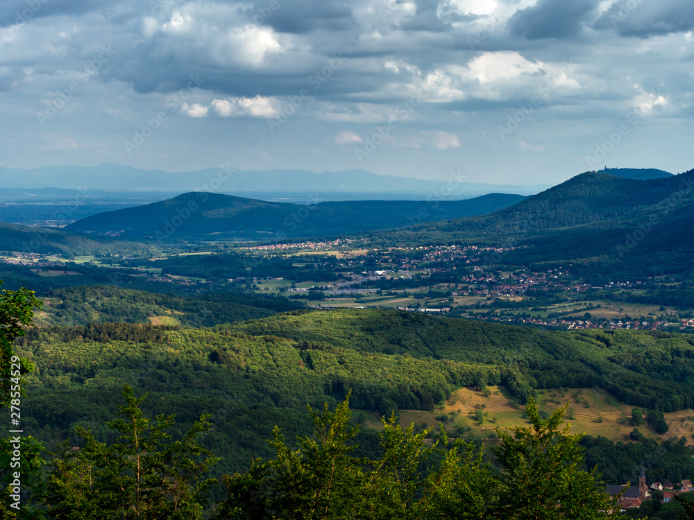 Obraz premium Spacious mountain landscape. A view from the mountain to the valley of Rhine and the village of Alsace.